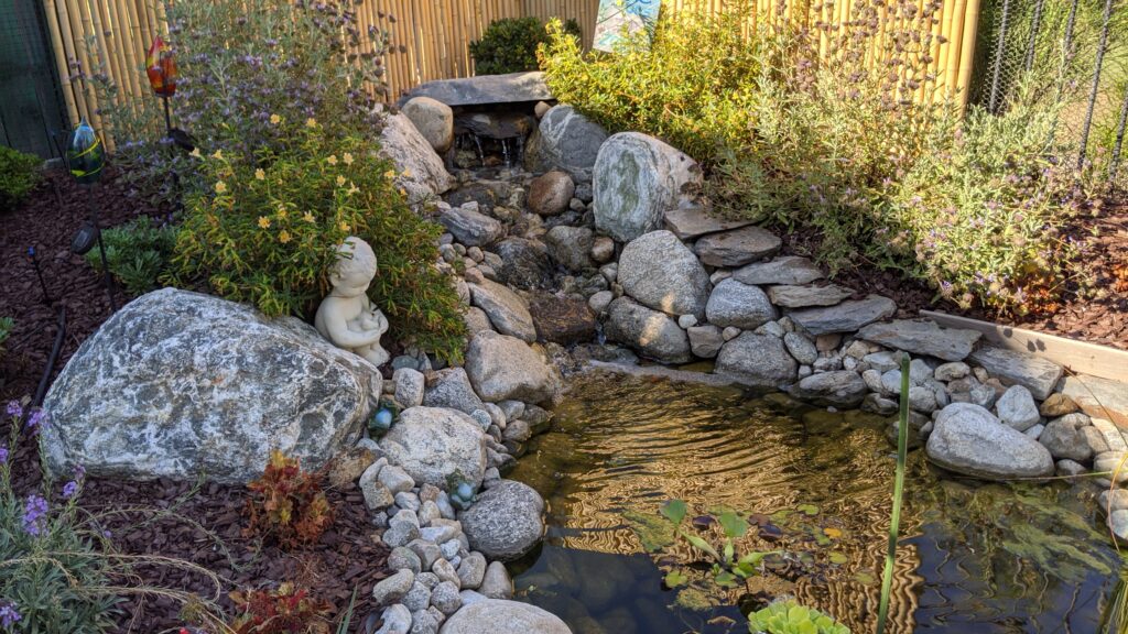 An example of our landscaping service is a small natural waterfall and pond, incorporating rounded stones and natuve plants